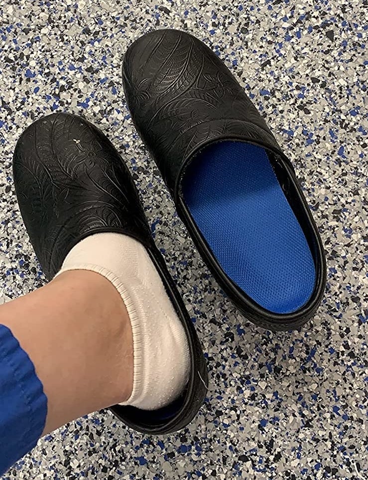 Reviewer with one foot in slipper shoe with other shoe showing blue insole inserted