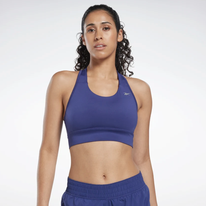 model wearing dark blue racerback sports bra with matching running shorts