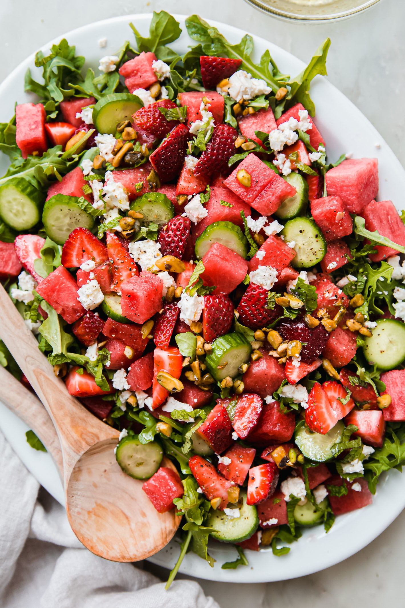 Arugula salad with feta, watermelon and strawberry.