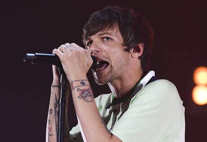 Louis singing into a microphone