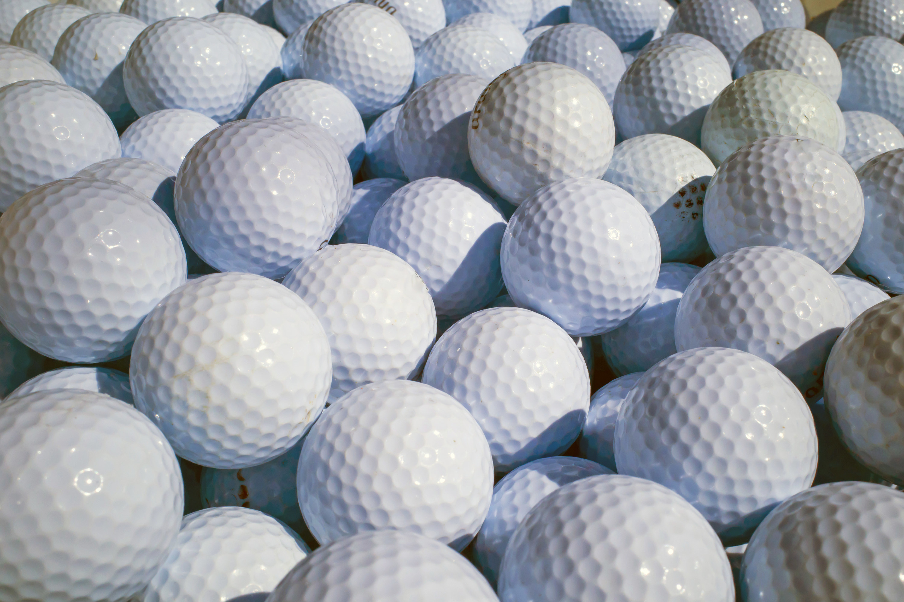 a pile of golf balls on top of one another