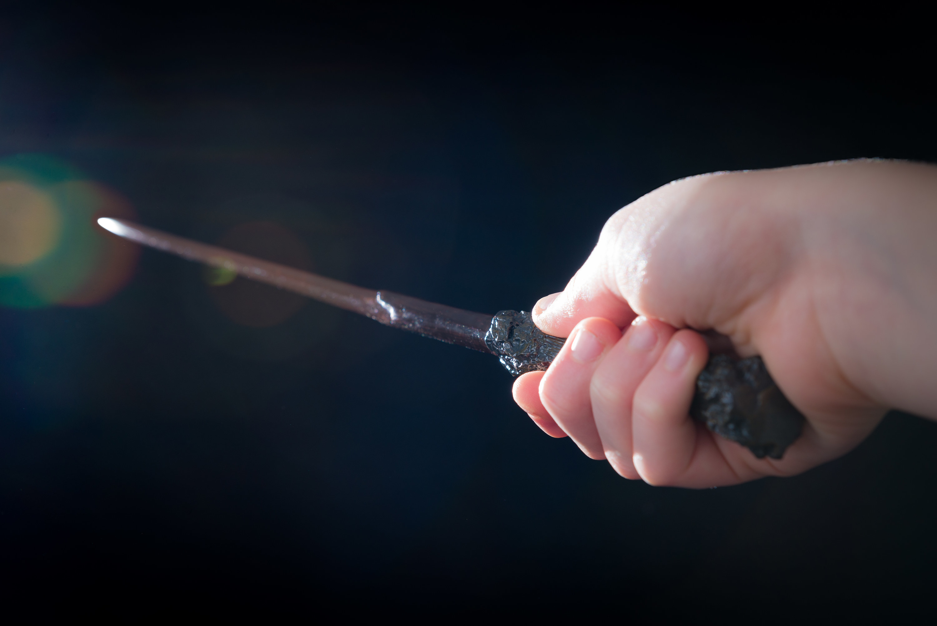 A person holding a wand