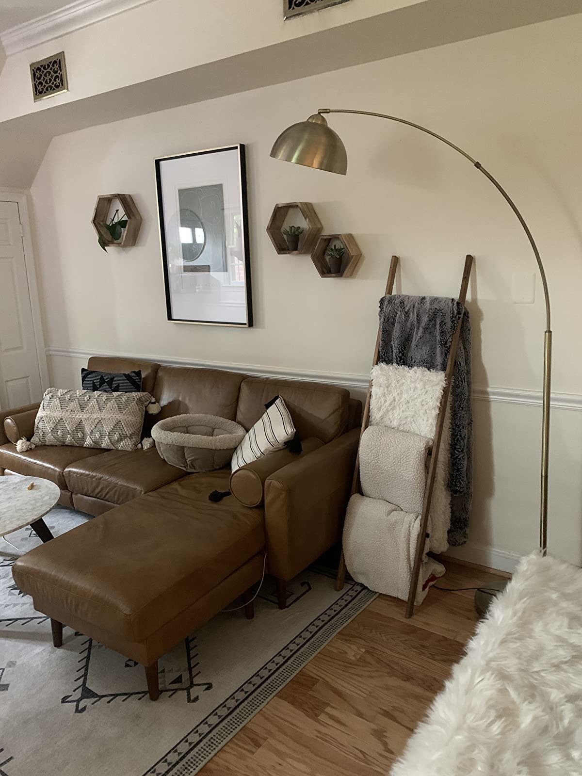Reviewer image of lamp in a living room next to blanket ladder and leather sectional