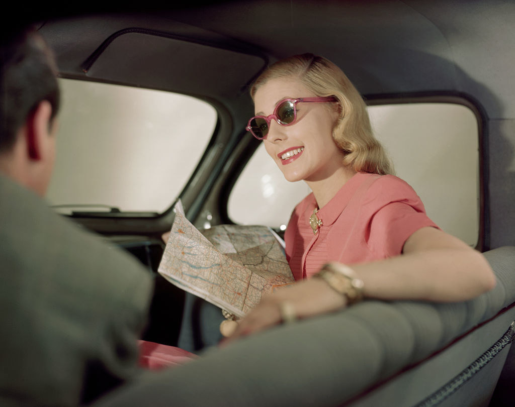 character looking at a map in the car