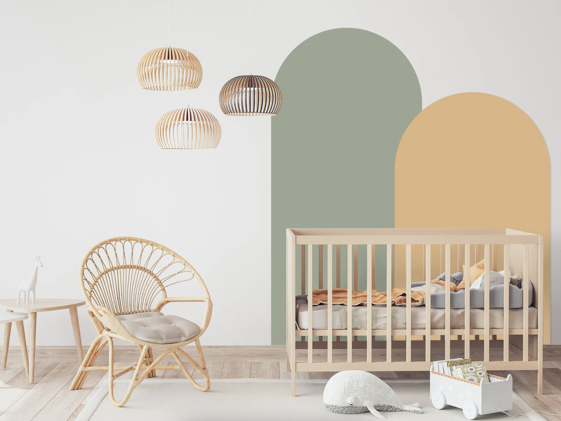 A nursery is shown with the green and beige arch wall decals on the wall