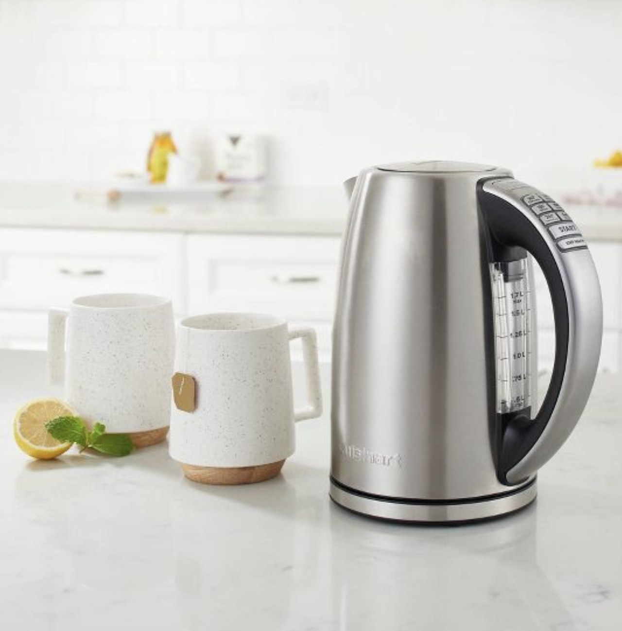 programmable kettle on a countertop next to two mugs