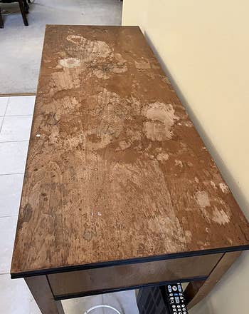 a reviewer's wooden table looking scuffed up and scratched