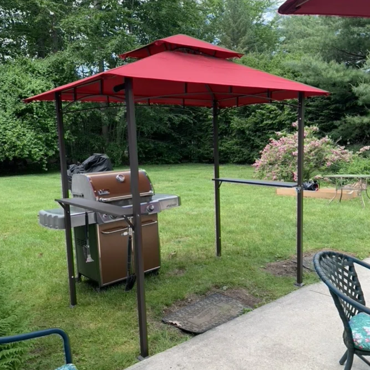 reviewer's image of the gazebo in red over a grill outside