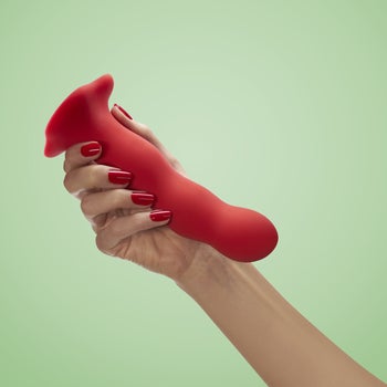 Model holding red dildo