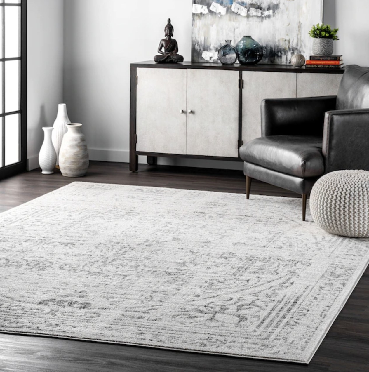 the gray and white distressed rug in a living room
