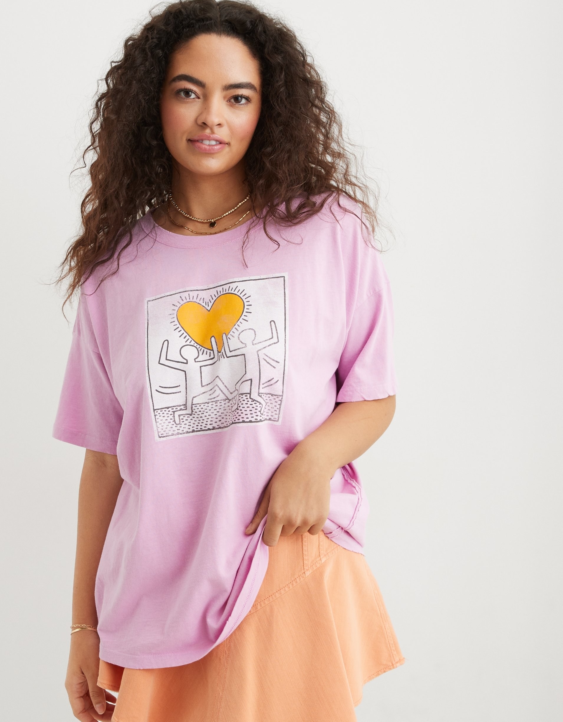model in the oversized pink tee with a keith haring art graphic