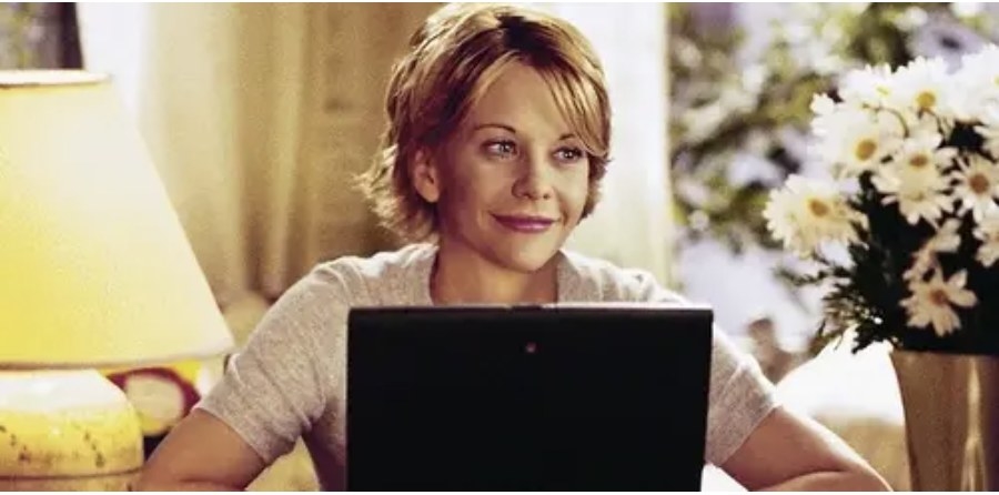 Meg smiling in front of a laptop