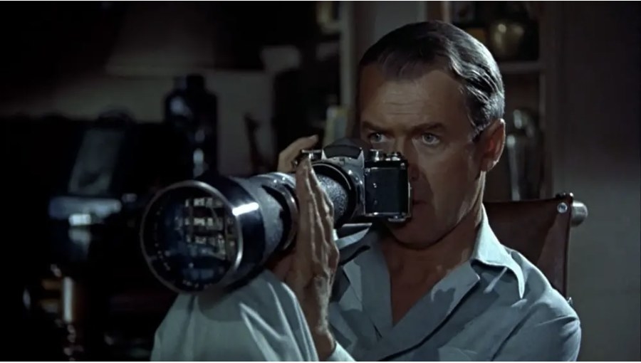 James Stewart looking through a very large camera lens