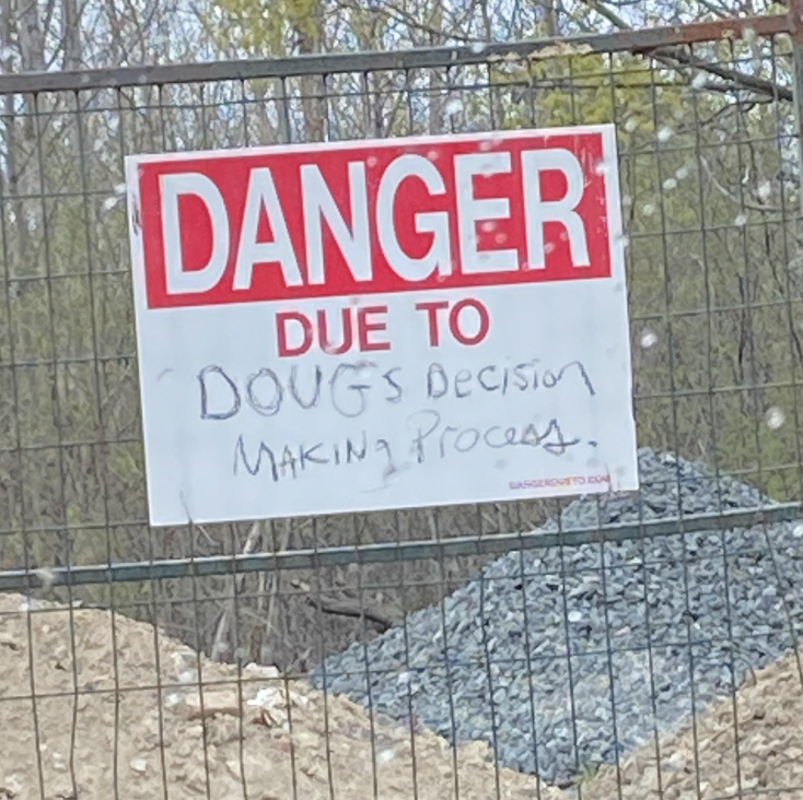 sign reading danger due to doug&#x27;s decisions