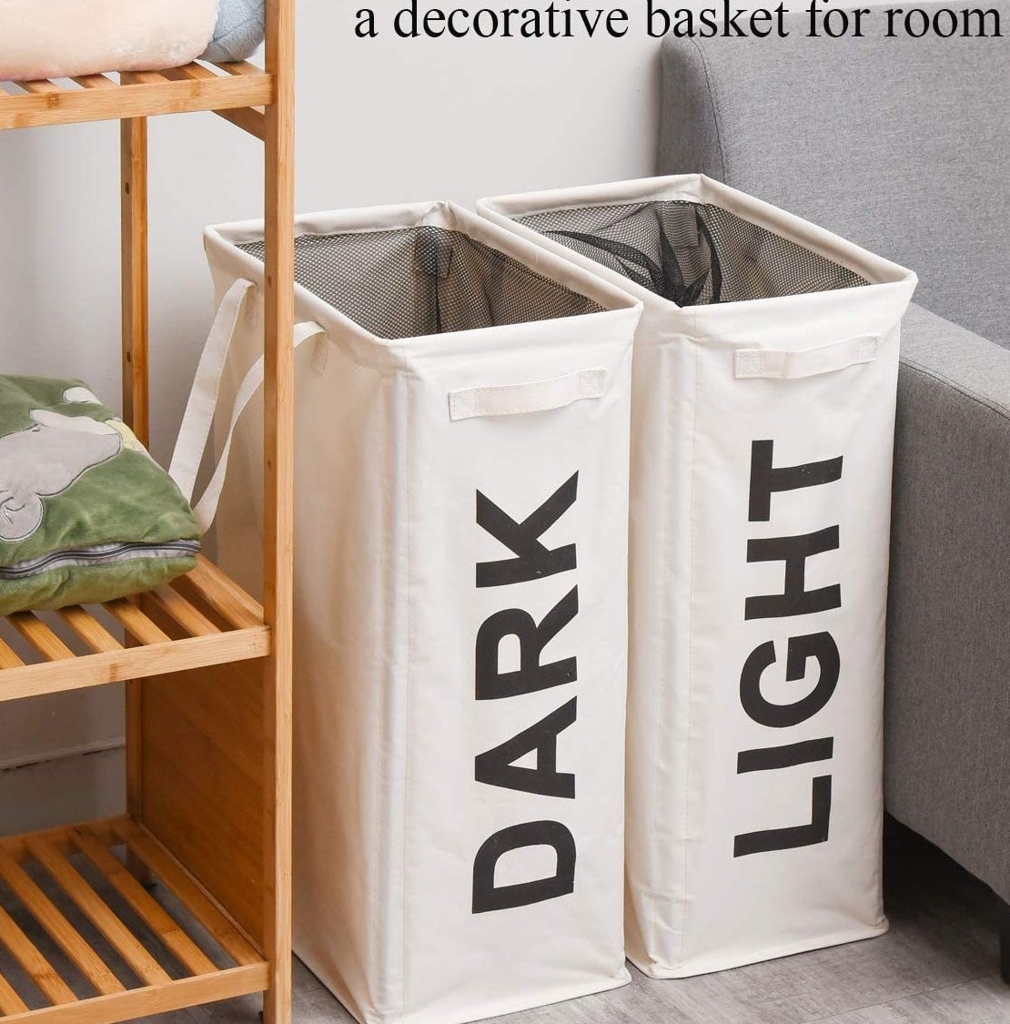 a pair of light and dark hampers tucked next to a couch
