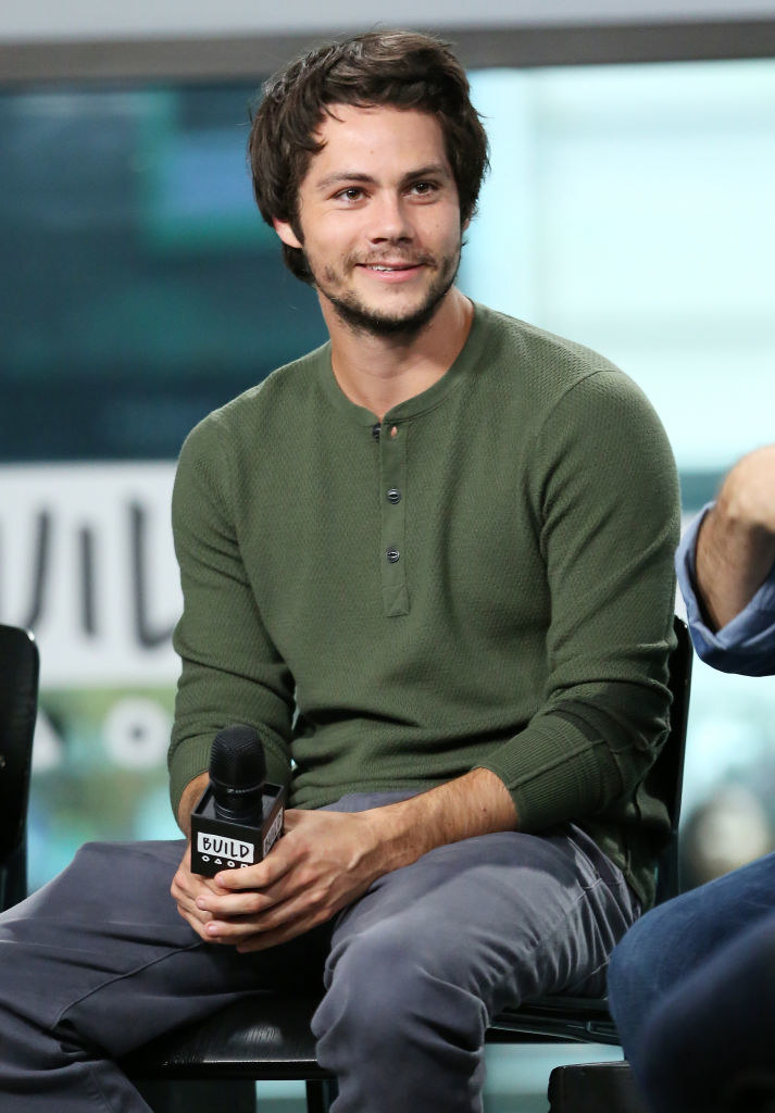 Dylan O&#x27;Brien sitting and holding a mic
