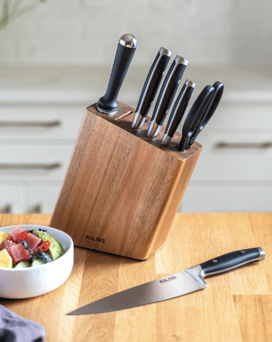 The knife set is shown on a butcher block