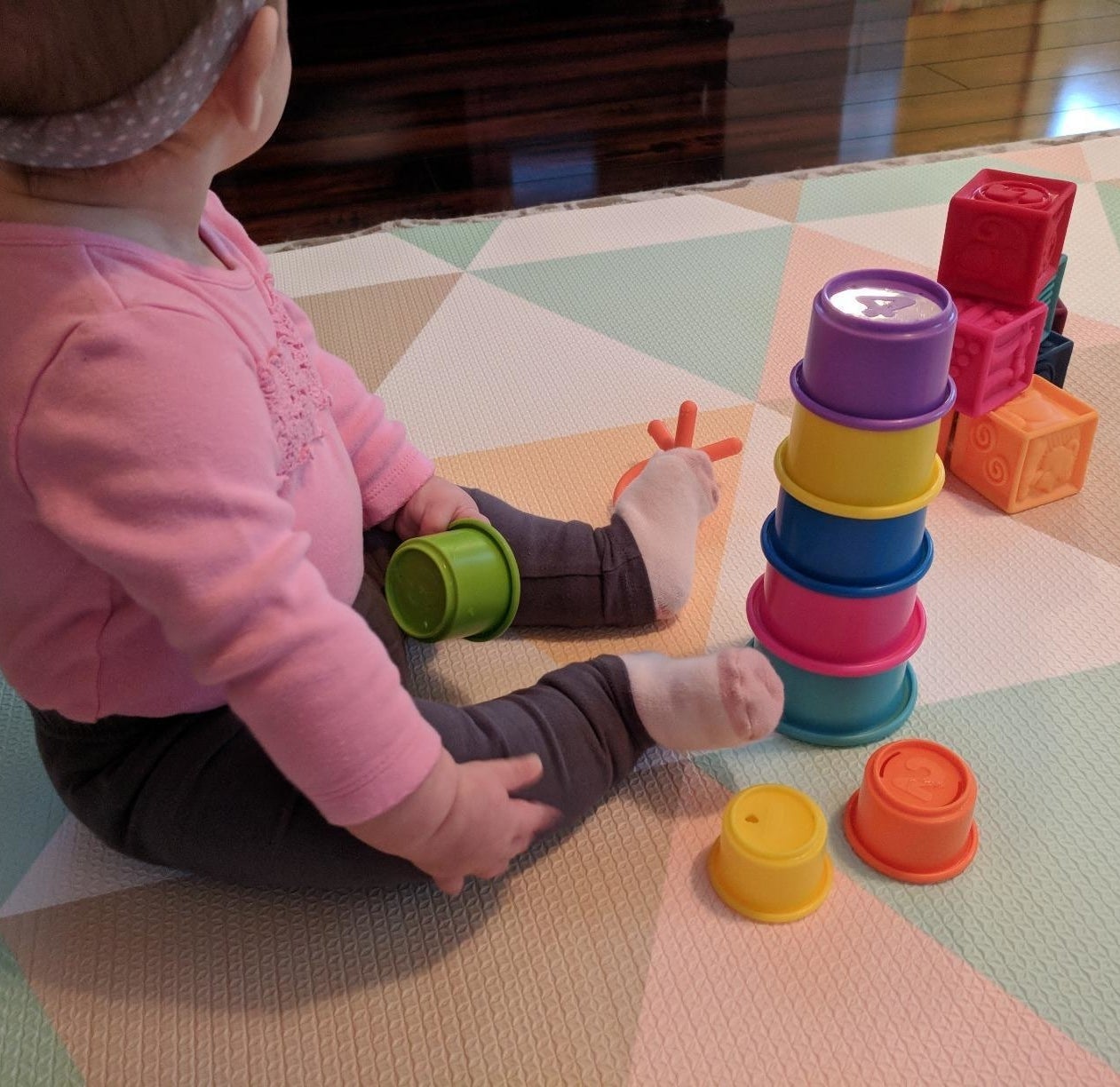 reviewer&#x27;s photo of a baby with the stacking cups