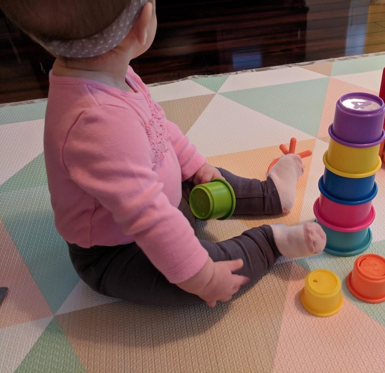 reviewer's photo of a baby with the stacking cups