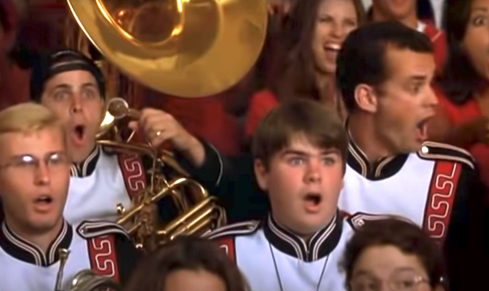 Guys in a marching band with surprised faces