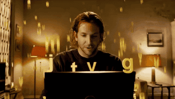 Bradley Cooper as Eddie Mora in &quot;Limitless&quot; writing at a laptop