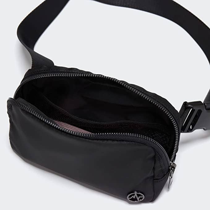 The belt bag opened against a plain background