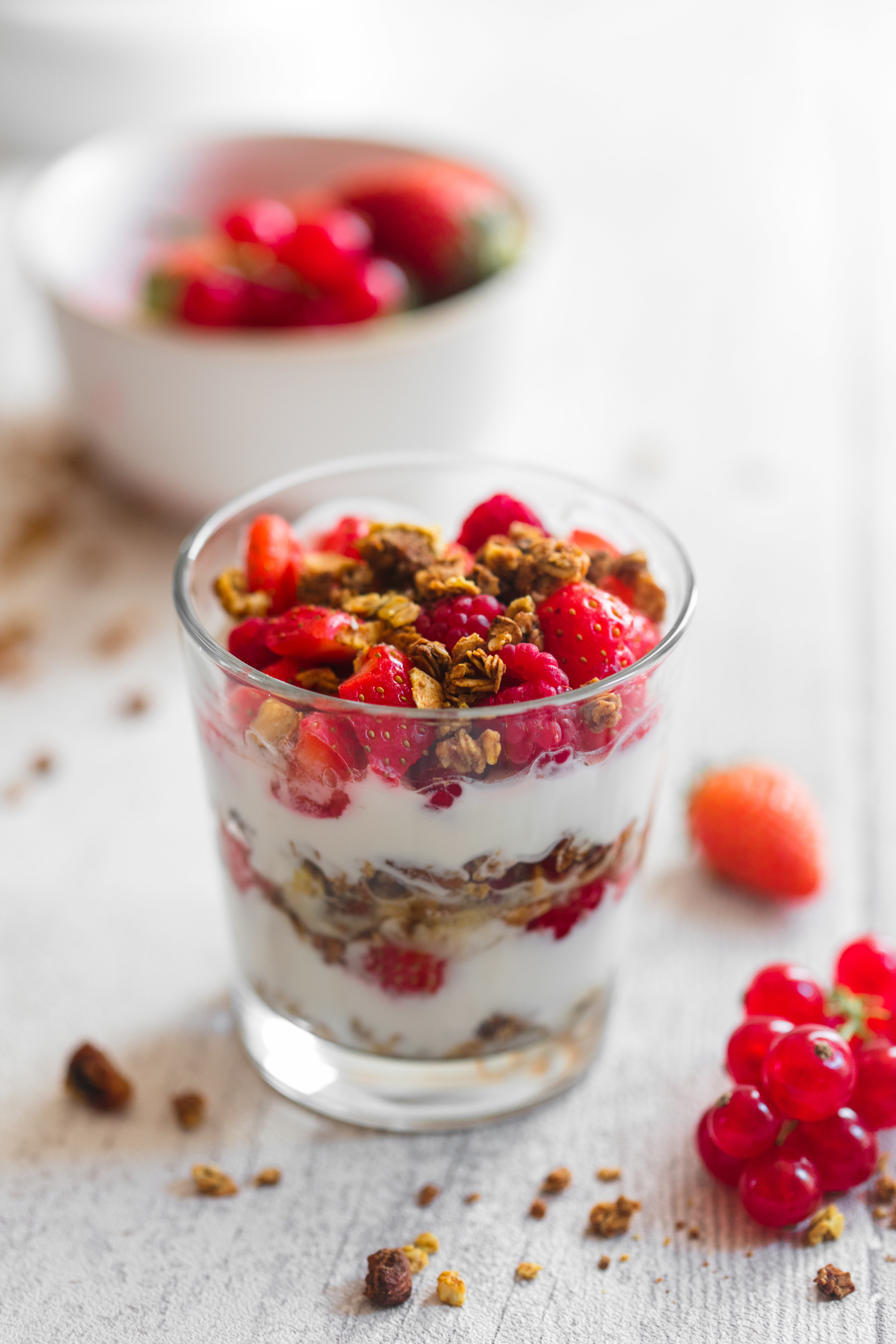 Closeup of a strawberry and granola yogurt parfait