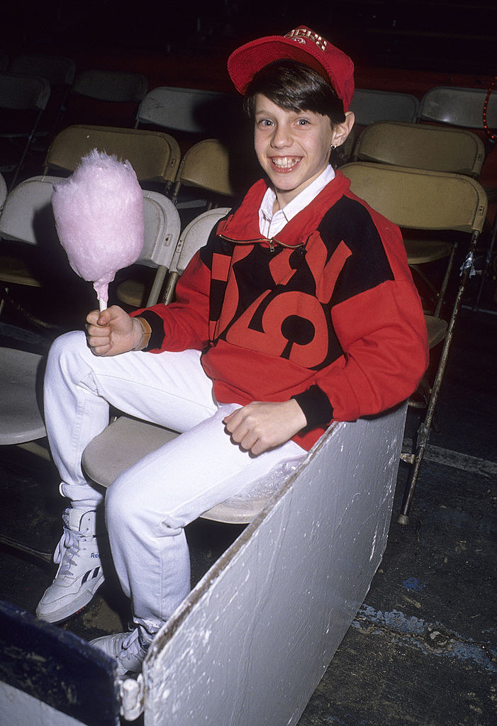Omri Katz as a child holding cotton candy