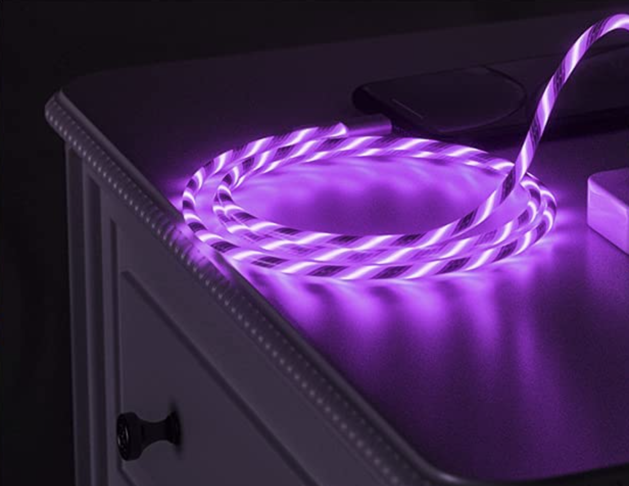 the light up charger on a table in a room lit up in the dark