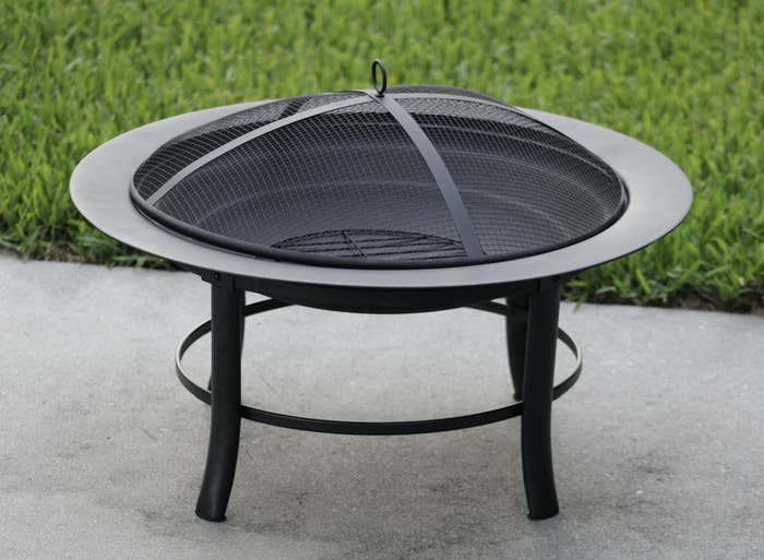 the black fire pit on a patio