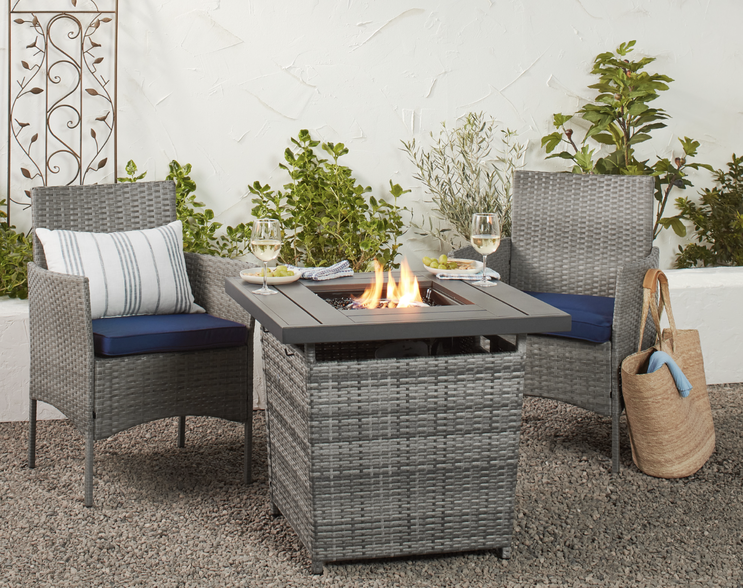 the fire pit on a patio with chairs around it