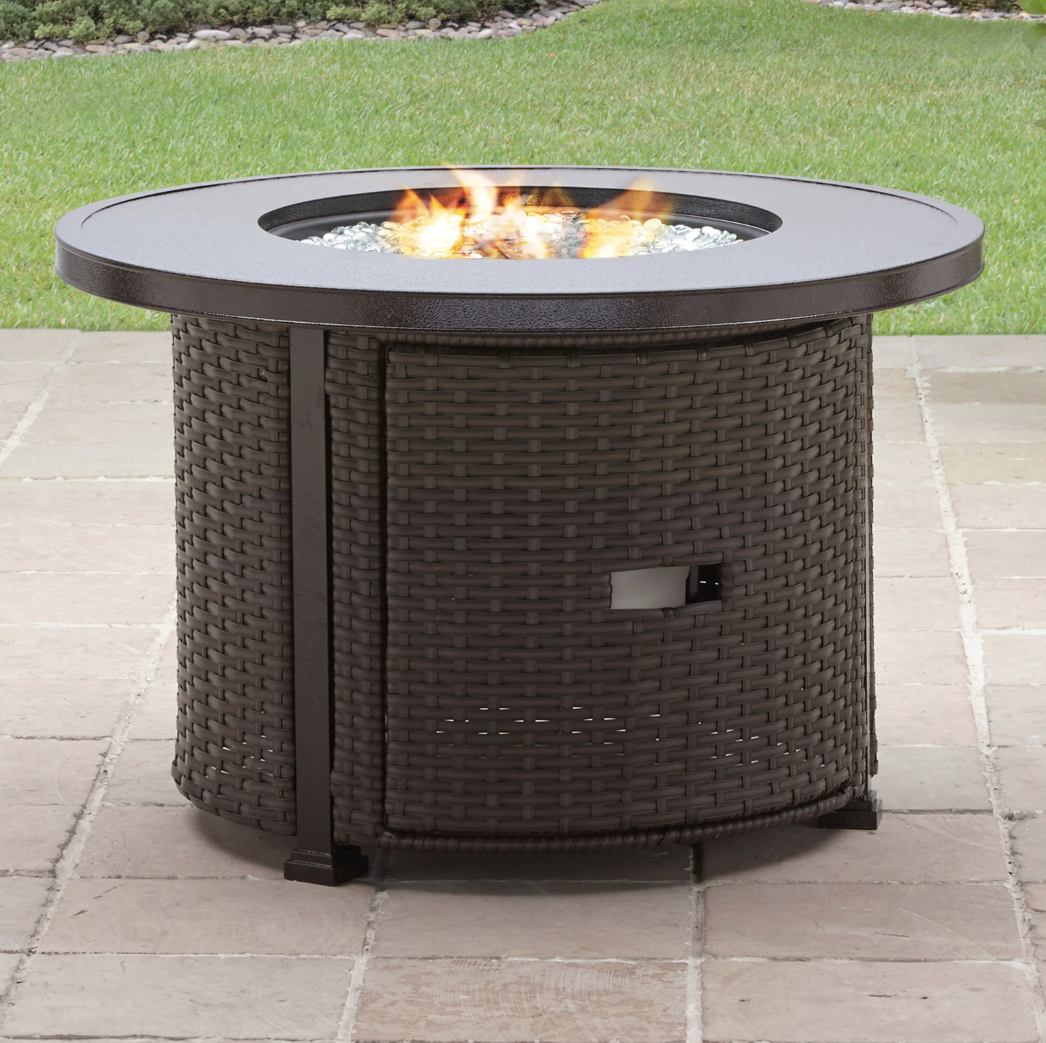 the fire pit on a patio with the top lit