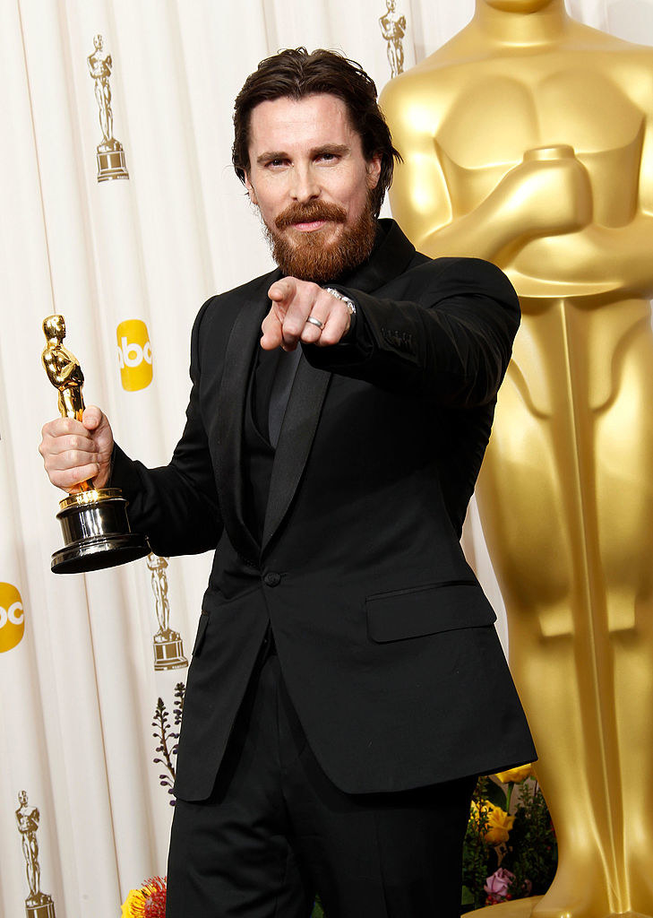 Christian Bale holding an Oscar