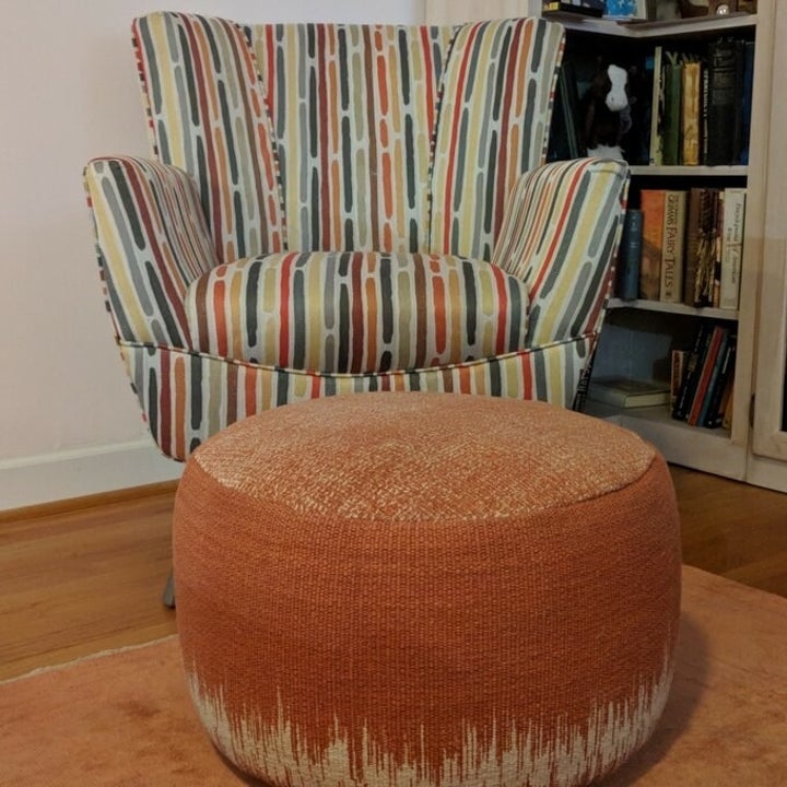 Reviewer photo orange pouf in front of multicolor chair