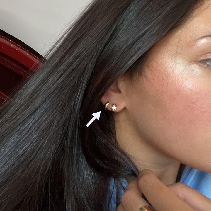 The earring on Melina's ear