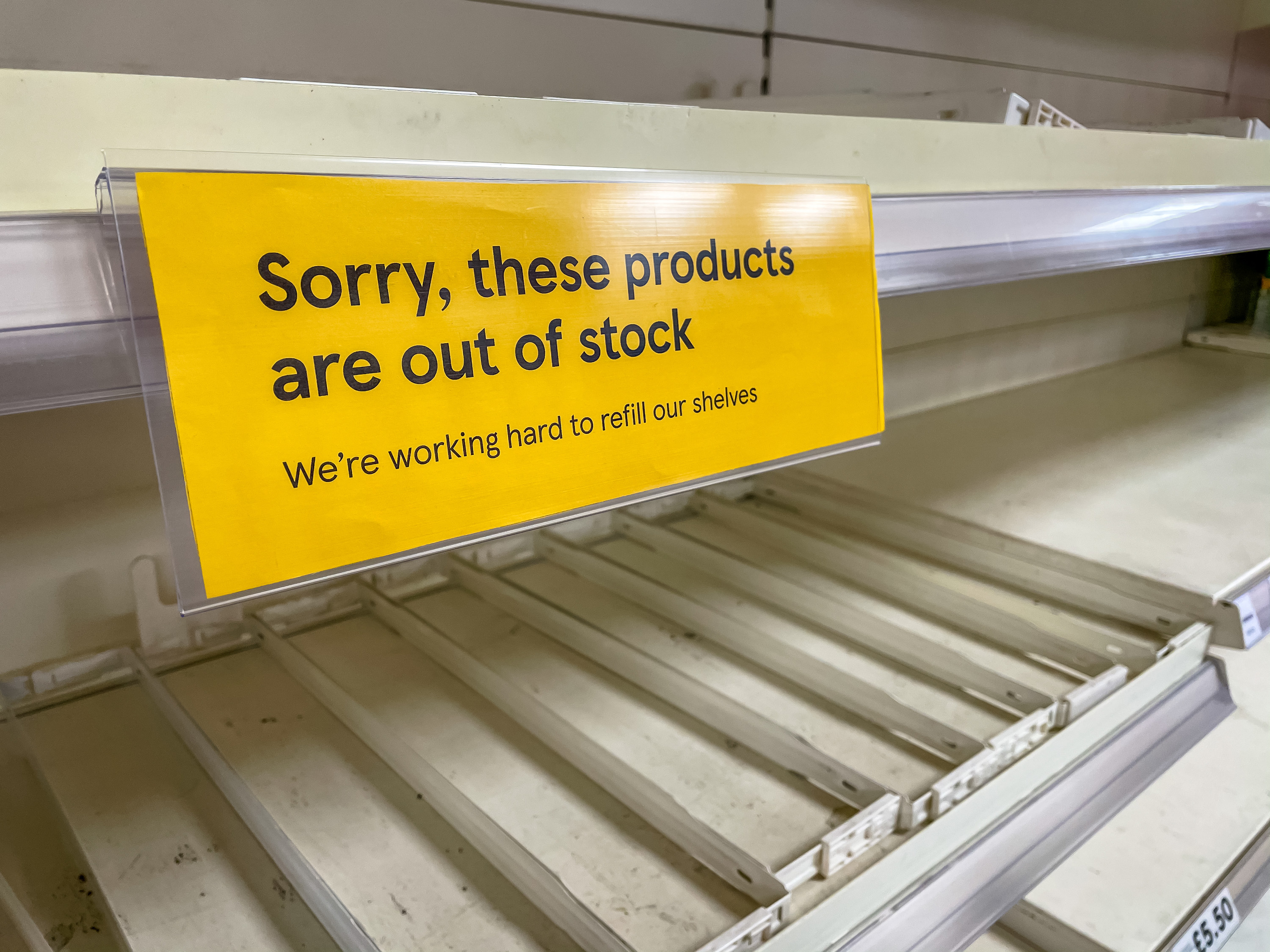 empty shelf with a sign that says sorry these products are out of stock