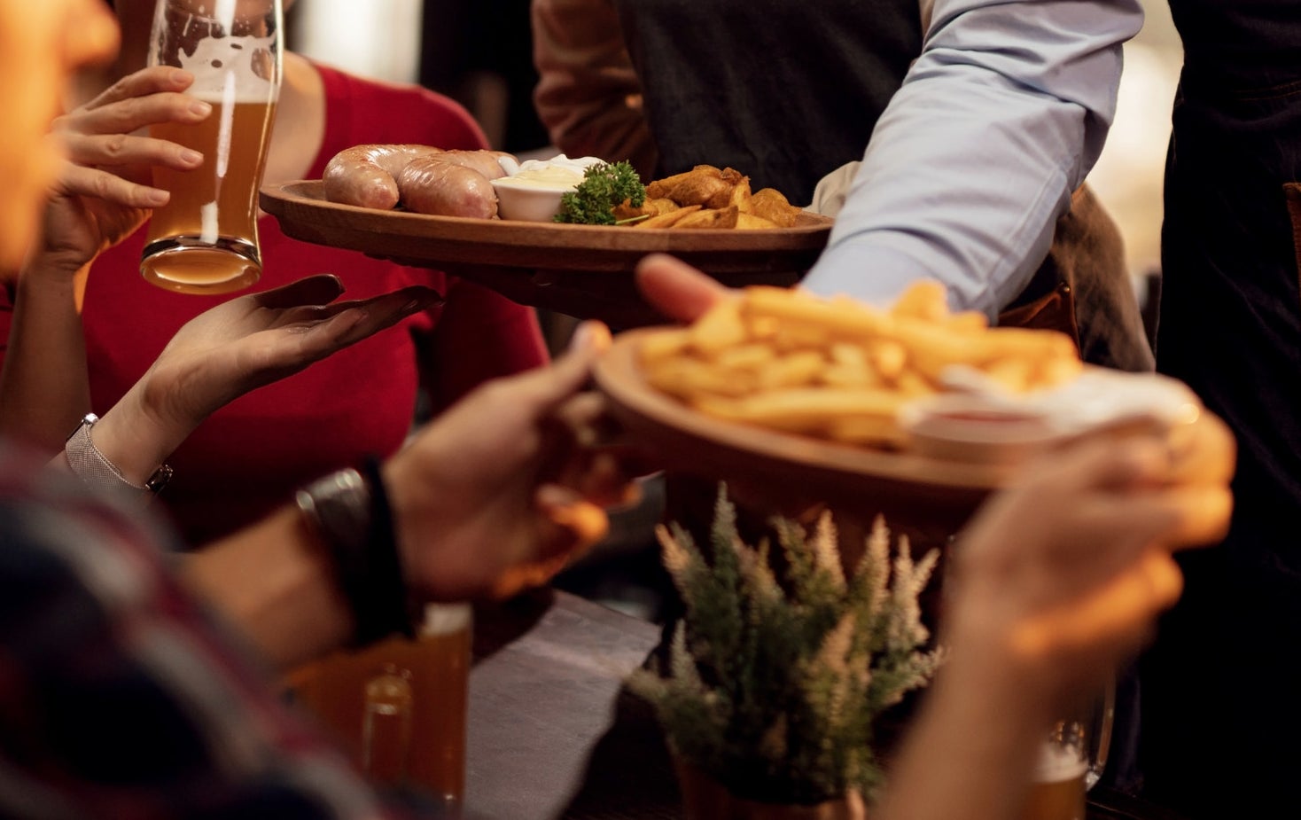 A waiter handing people their plates