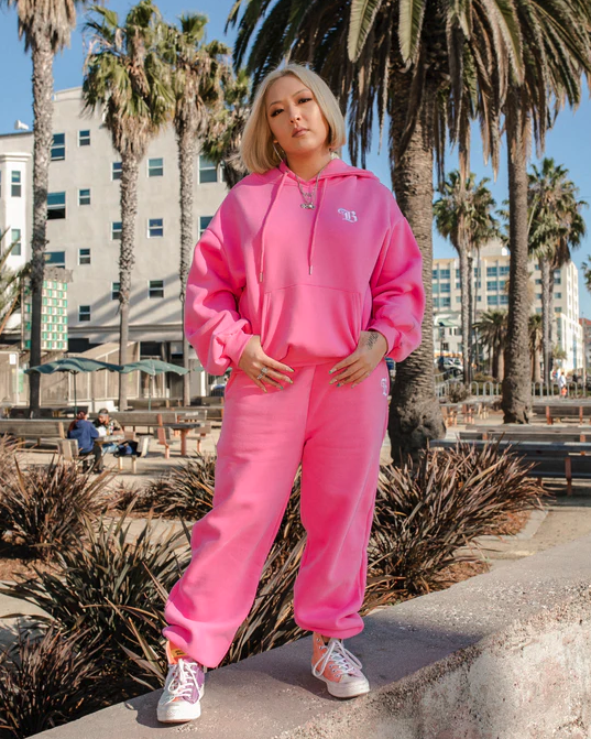 model posing in the hot pink sweats set