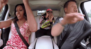 A carpool with three people dancing and singing inside