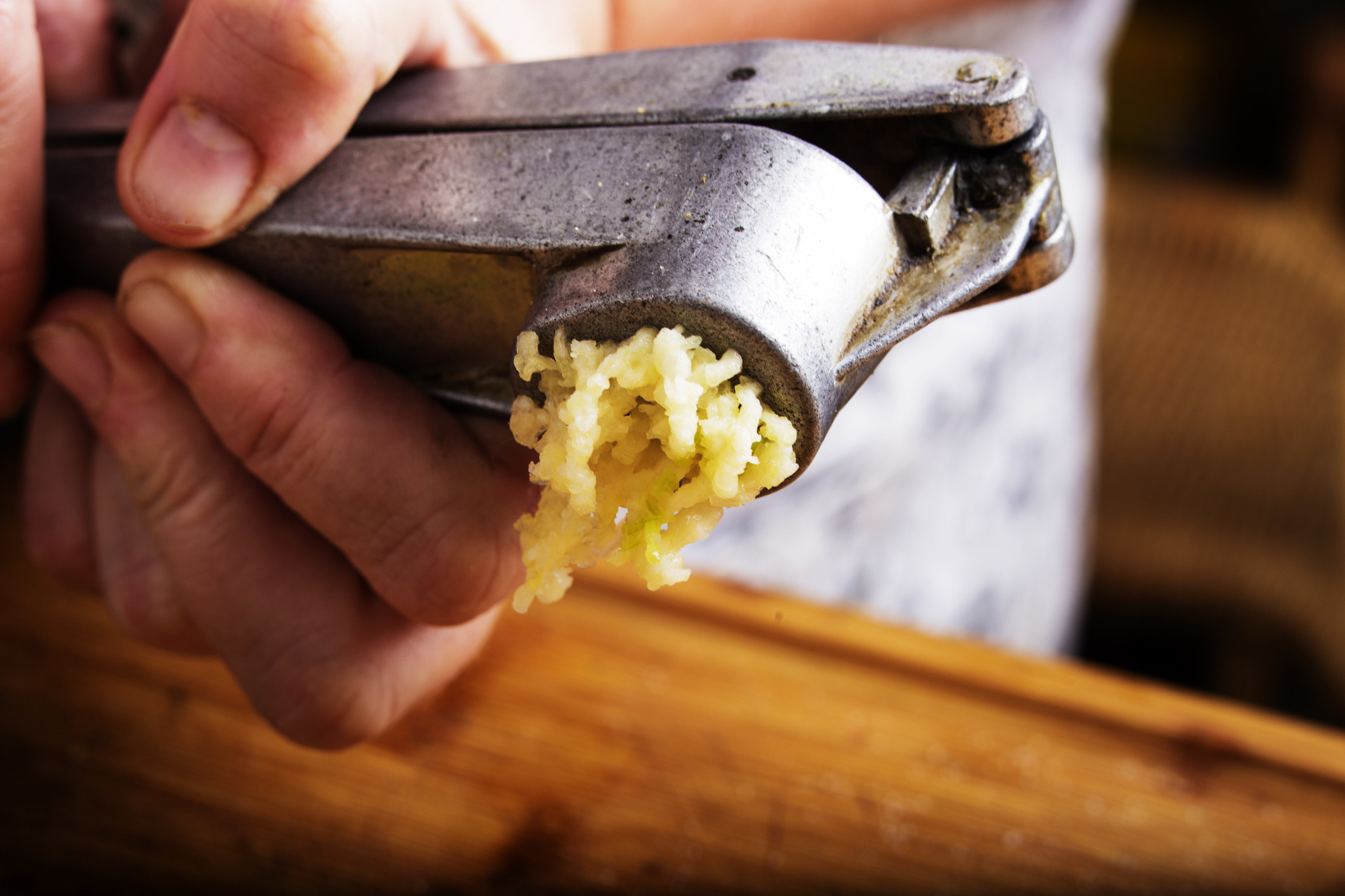 Crushing garlic in a press.