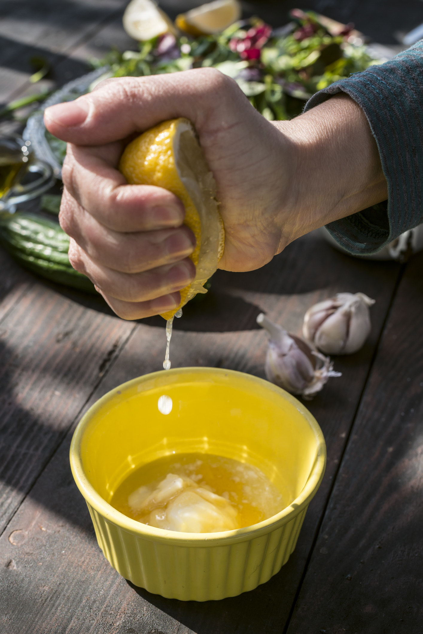Squeezing lemon juice into a ramekin.