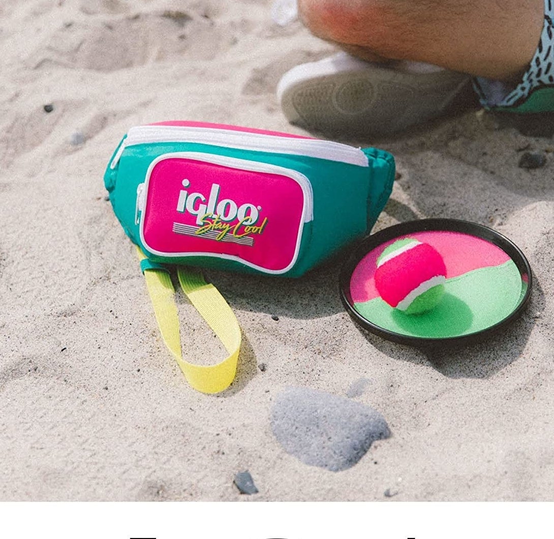 a vibrant fanny pack in sand on a beach