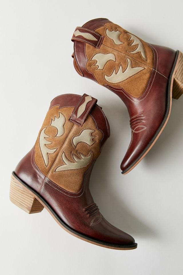 brown, light brown, and cream colored patterned mid-height cowboy boots with a slight wood heel