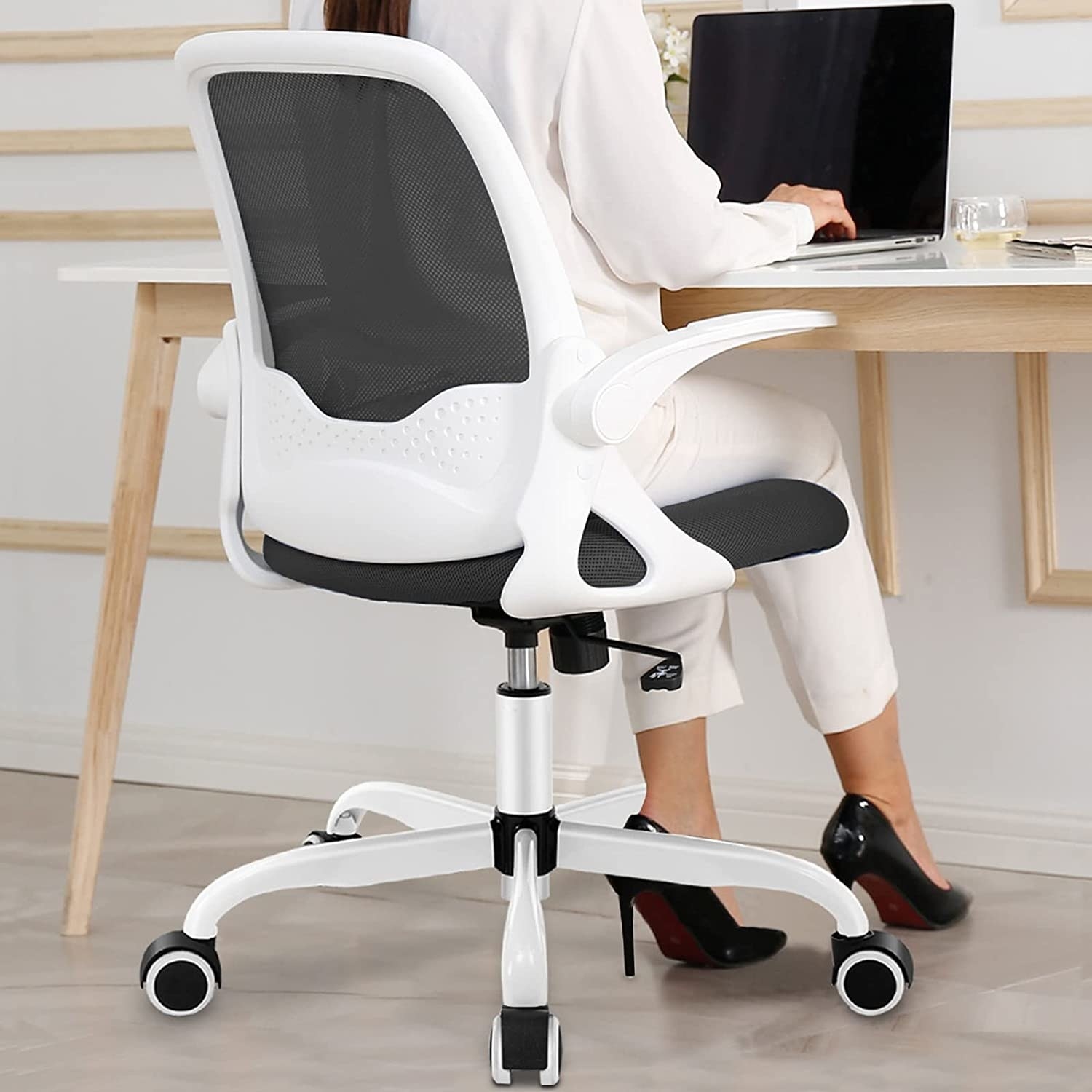 model sitting in desk chair