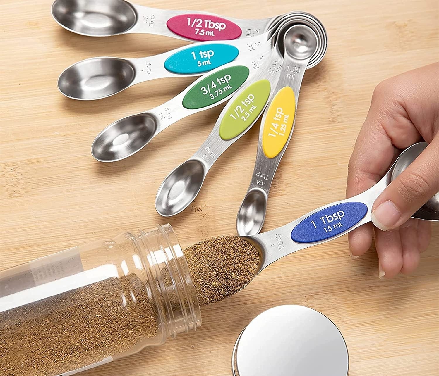 person measuring out spices on a measuring spoon