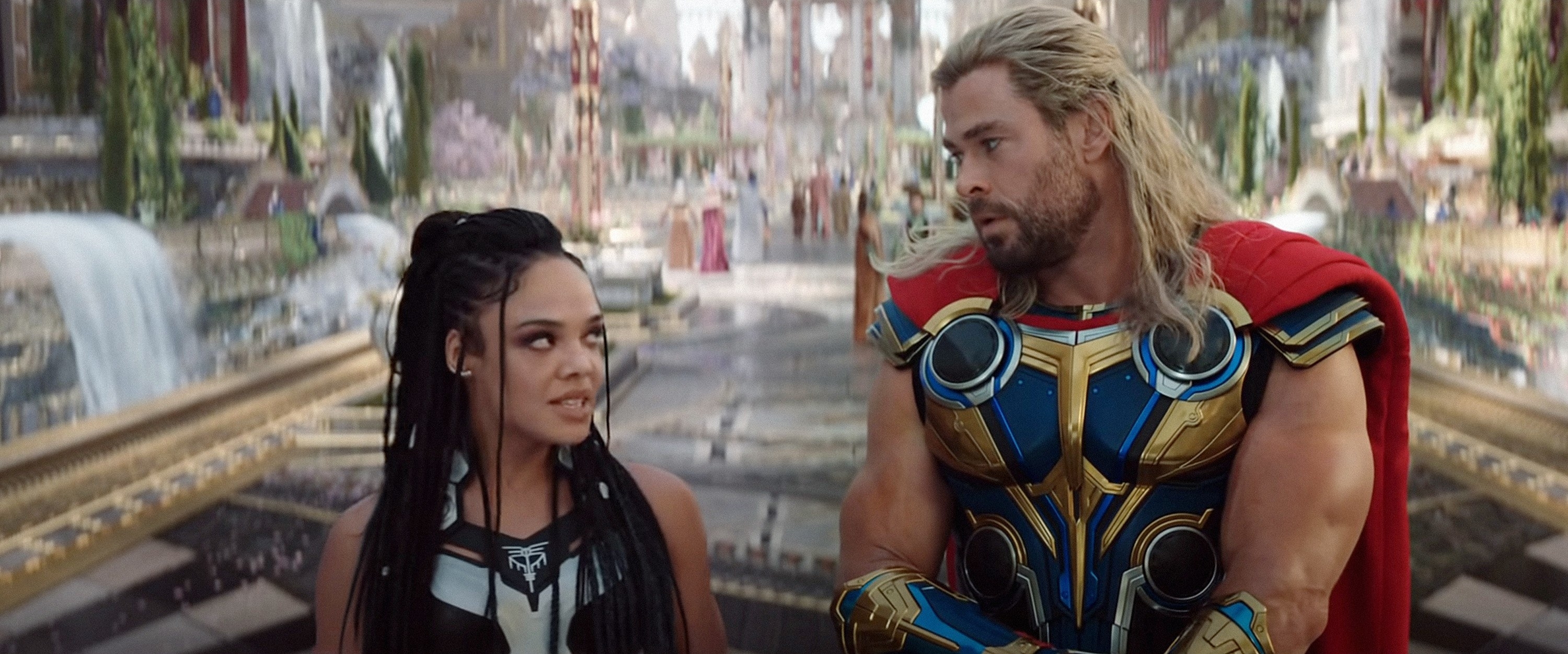 Tessa standing next to Chris Hemsworth in a scene from Thor: Love and Thunder