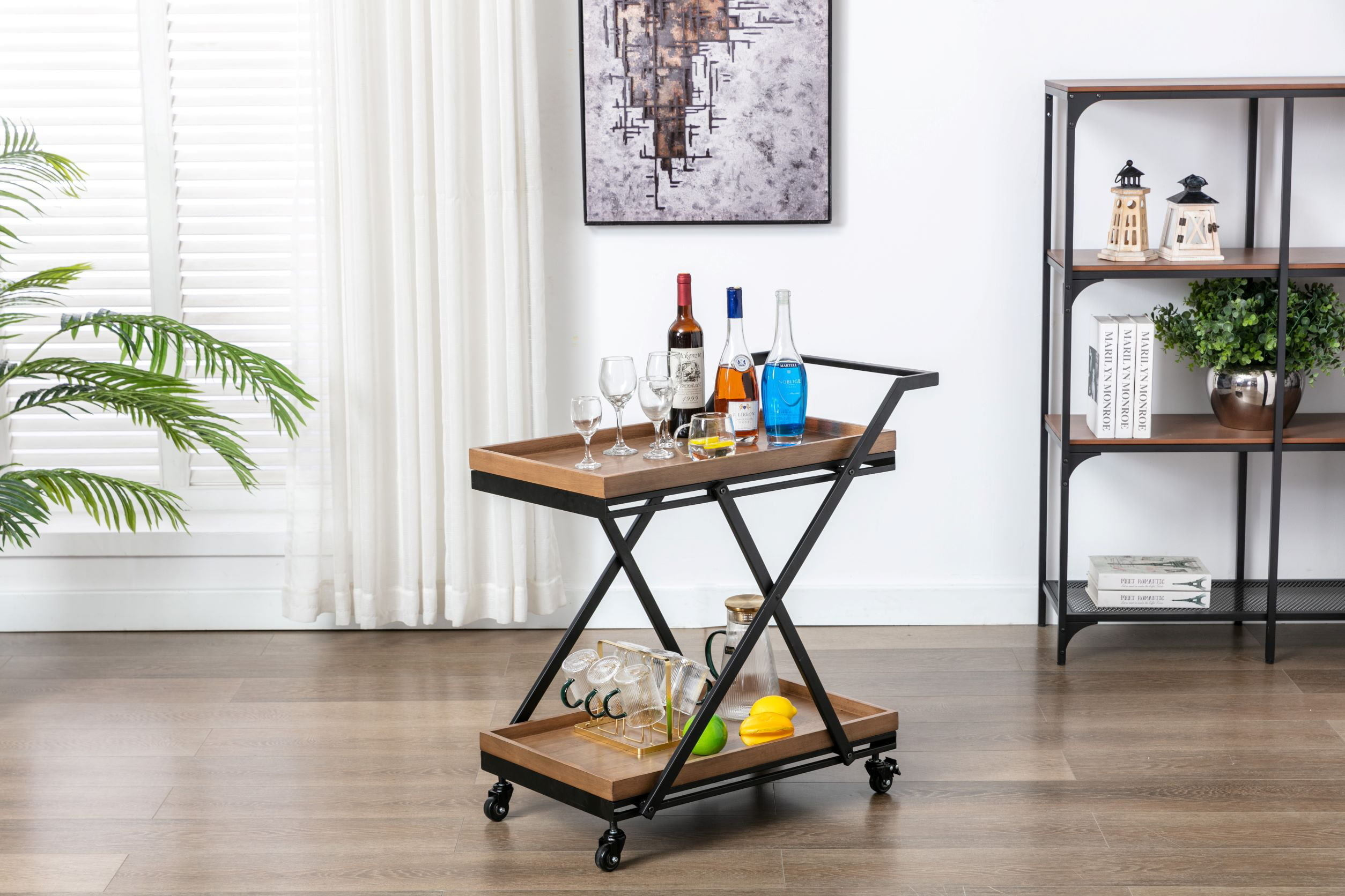 the bar cart with bottles and glasses on it