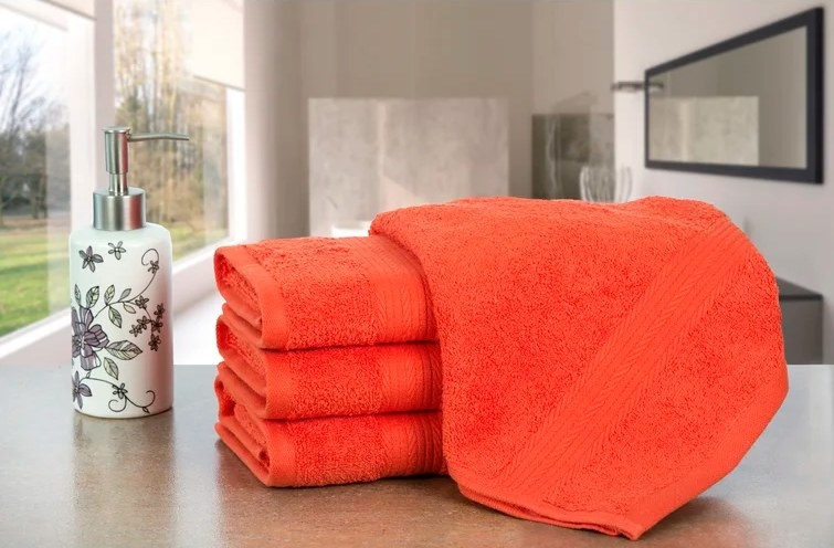A set of four highly-absorbent bath towels in orange