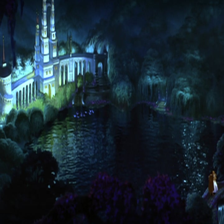 A landscape showing the castle and Odette and Derek kissing on a bridge