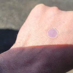 purple sticker on hand